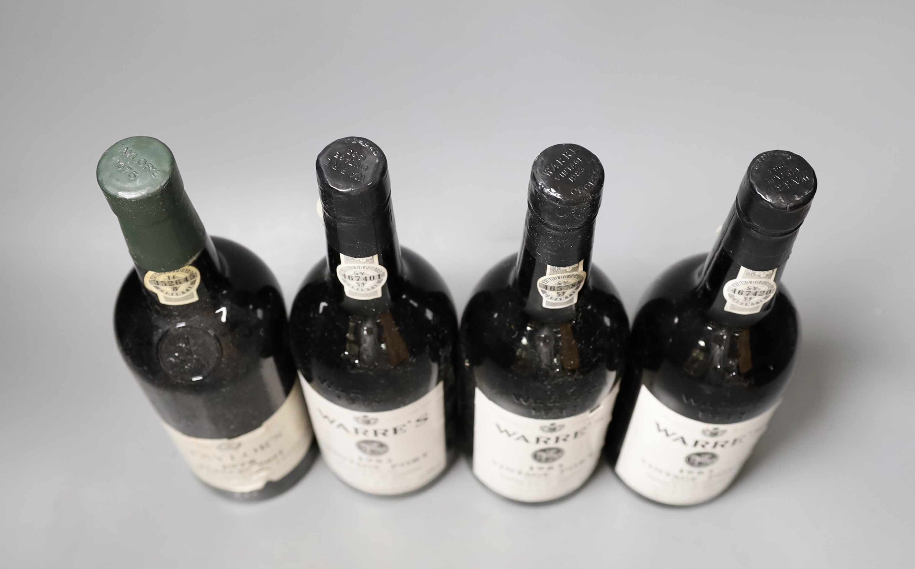 Three bottles of Warre’s 1983 vintage port and a bottle of 1975 Taylors (4)